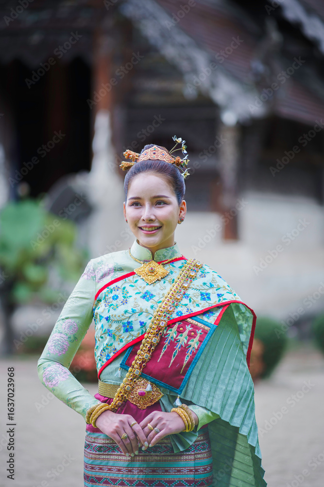 Fototapeta premium Pretty Asian Thai woman wearing traditional Thai dress costumes according to Thai culture at the ancient temple in famous tourist attraction in Thailand.
