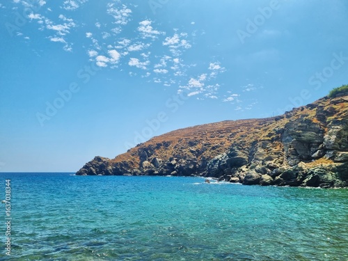 The coast of the island of Sifnos, the Aegean Sea.
Crystal clear waters and rocky coastline of Sifnos island in the Aegean Sea in summer. the landscape of a Greek island.