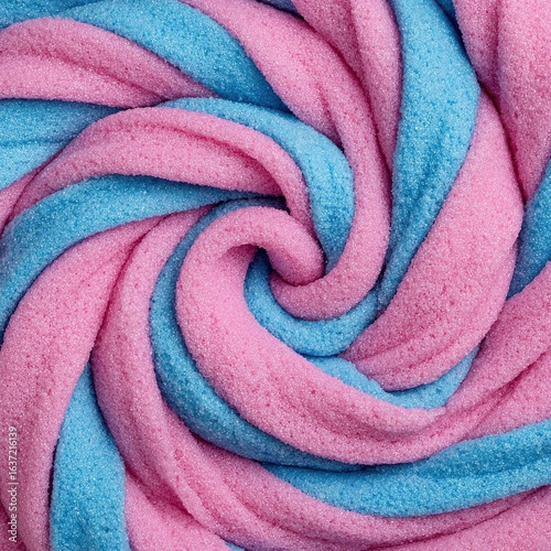 Close-up of a swirled, pastel candy.  Spiral of light pink and light blue.  Textured, chewy surface