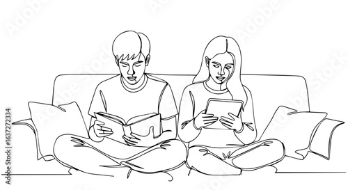 Couple relaxing on sofa reading book and tablet. Young man and woman enjoying leisure time together at home.  Peaceful couple on comfy couch reading book and using digital tablet.