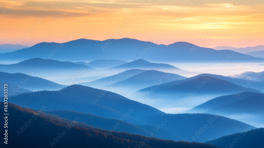 Fototapeta premium Misty mountain range at sunrise.