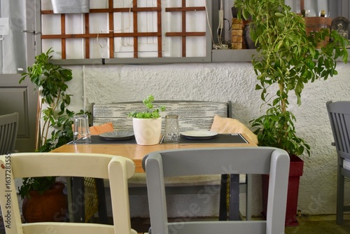 European outdoor cafe restaurant dining tables and chairs bench in Rethymno Crete Greece
