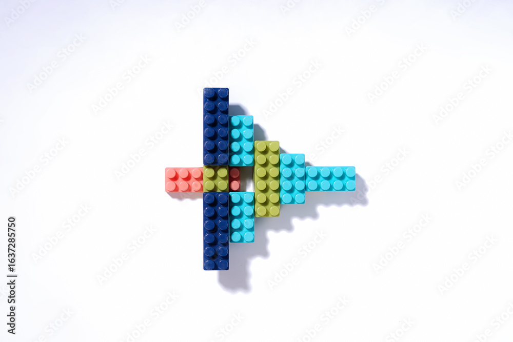 Fototapeta premium Abstract Arrow Shape Made of Colorful Building Blocks