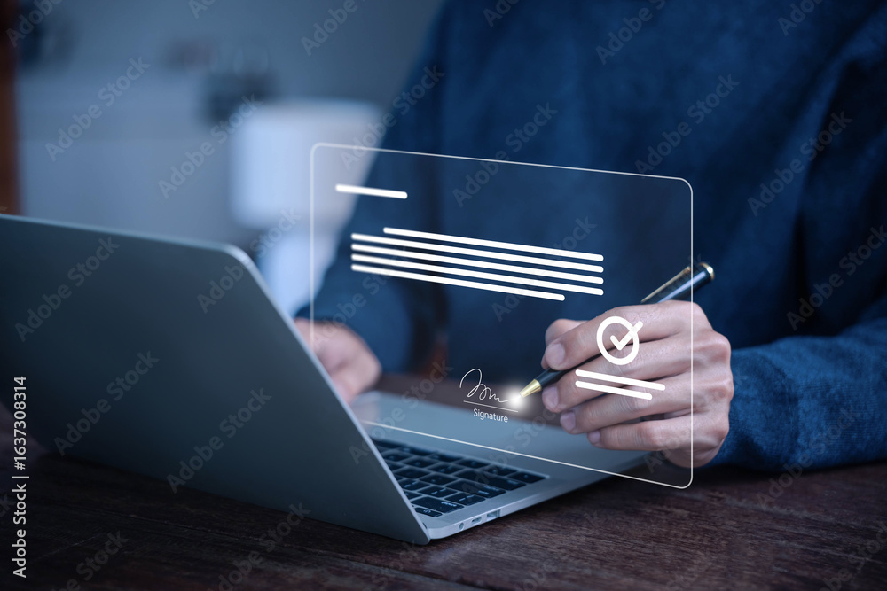 Obraz premium Man signing a digital document on a laptop using electronic signature technology, representing online contract approval, secure e-sign, paperless business agreement concepts. smart contract signature