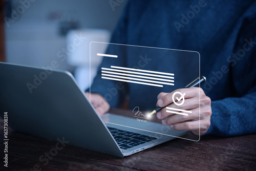 Man signing a digital document on a laptop using electronic signature technology, representing online contract approval, secure e-sign, paperless business agreement concepts. smart contract signature