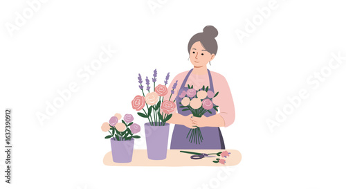 Florist woman arranges roses and lavender with scissors on a tan desk