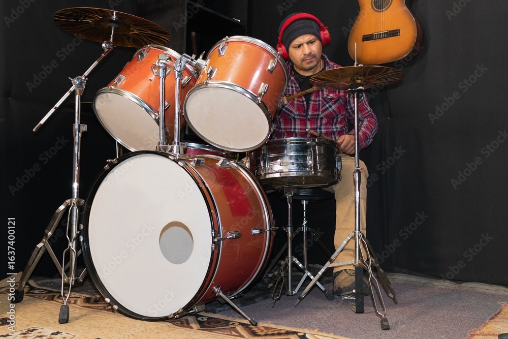 Fototapeta premium male drummer practicing in the studio