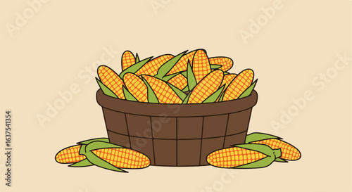 A basket is filled with corn and some other ears are on the tan ground
