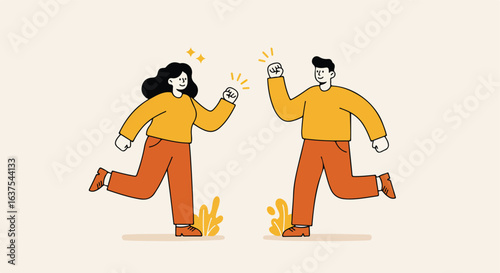 Joyful couple raising fists in the air, celebrating, wearing orange clothes on light background