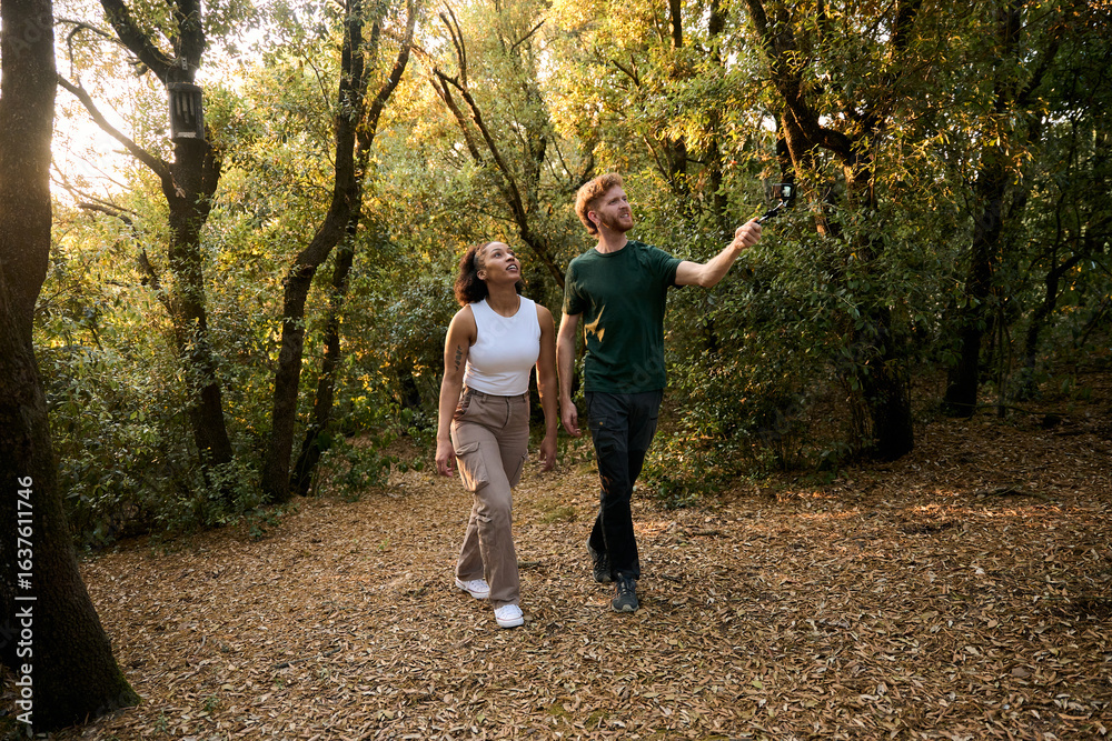 Fototapeta premium Biologists exploring forest with action camera on gimbal