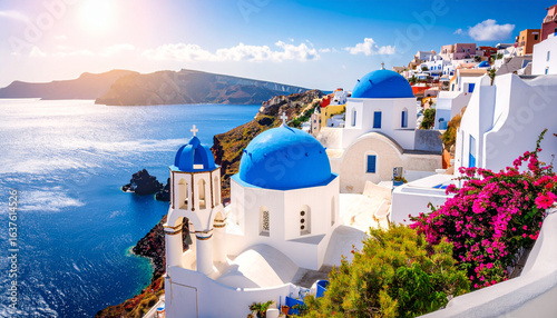 Sun-drenched Santorini village with iconic blue-domed churches overlooking the Aegean Sea.