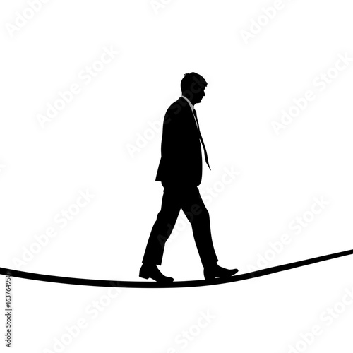 Silhouette of businessman balancing on rope against white background. Silhouette represents challenge and risk, walking cautiously.