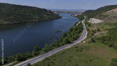  Lakeside Journey: Dynamic Drone Reveal of Boğazköy Dam Road and Majestic Mountains in Bursa.