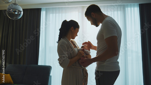 Fotografía Happy parents holding their newborn baby at home