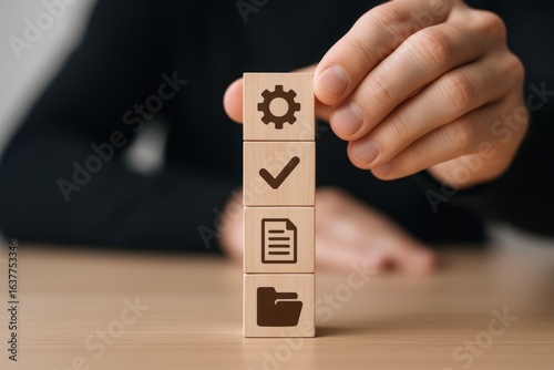 Workflow Optimization: Hand Stacking Wooden Blocks Representing Process Steps for Efficiency and Productivity in Business