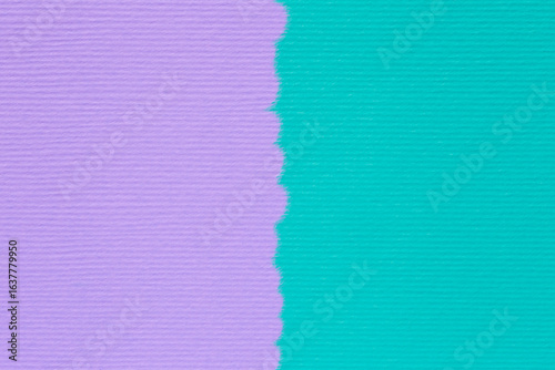 close up of striped craft paper stained in turquoise and violet colors with uneven merge line