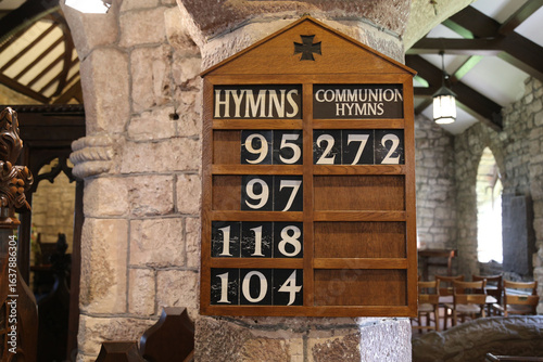 фотографія A hymn board inside an ancient English Church.