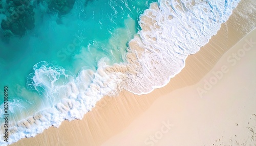 Aerial beach view with turquoise waves, light sand, and foamy surf in motion
