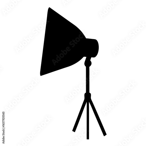 Silhouette of studio lighting equipment with softbox on a tripod stand
