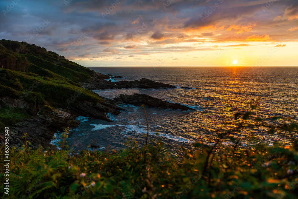 Fototapeta premium Sunset Over the Cantabrian Sea from the Rocky Coastline at the Foot of Mount Jaizkibel Around Cape Higuer