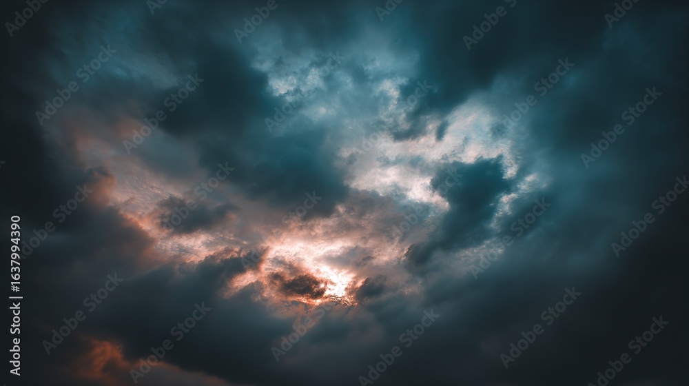 Obraz premium Blue and Orange Cloudy Sky Background with Golden Sunset Light – Hues of Azure and Amber Blending in Clouds, Bathed in Warm Golden Rays of the Setting Sun