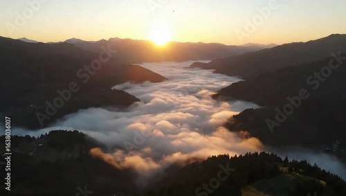 The sunrise above the mountains and the morning fog - the sunrise above the mountains. In the midst of the morning fog covering the valley below. 