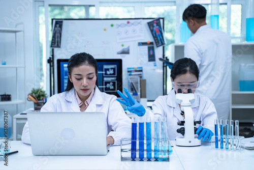 In the laboratory, several researchers and scientists, each focused on their own biology experiments, conduct detailed analysis to advance the field of science and deepen understanding.