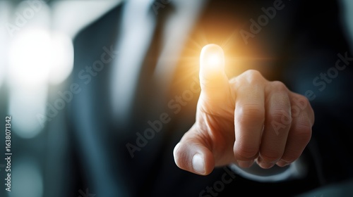 A person's fingertip points to a highlighted spot.
