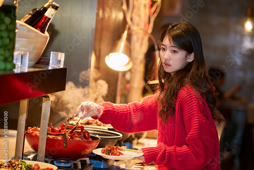 Картината върху платно A cute girl enjoying a hearty meal at the hotel buffet.