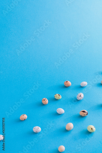 Colorful Speckled Eggs Spread Across a Vibrant Blue Background in the bottom right corner