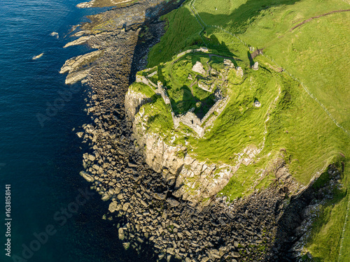 Aerial view of Duntulm Castle stands ruined on the north coast of Trotternish, on the Isle of Skye in Scotland, near the hamlet of Duntulm