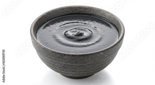 Chinese black sesame soup dessert in ceramic bowl isolated on white background for dessert and food photography