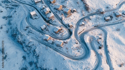 Fototapeta Naklejka Na Ścianę i Meble -  Distant alpine village in winter with snowy roads winding between small wooden homes