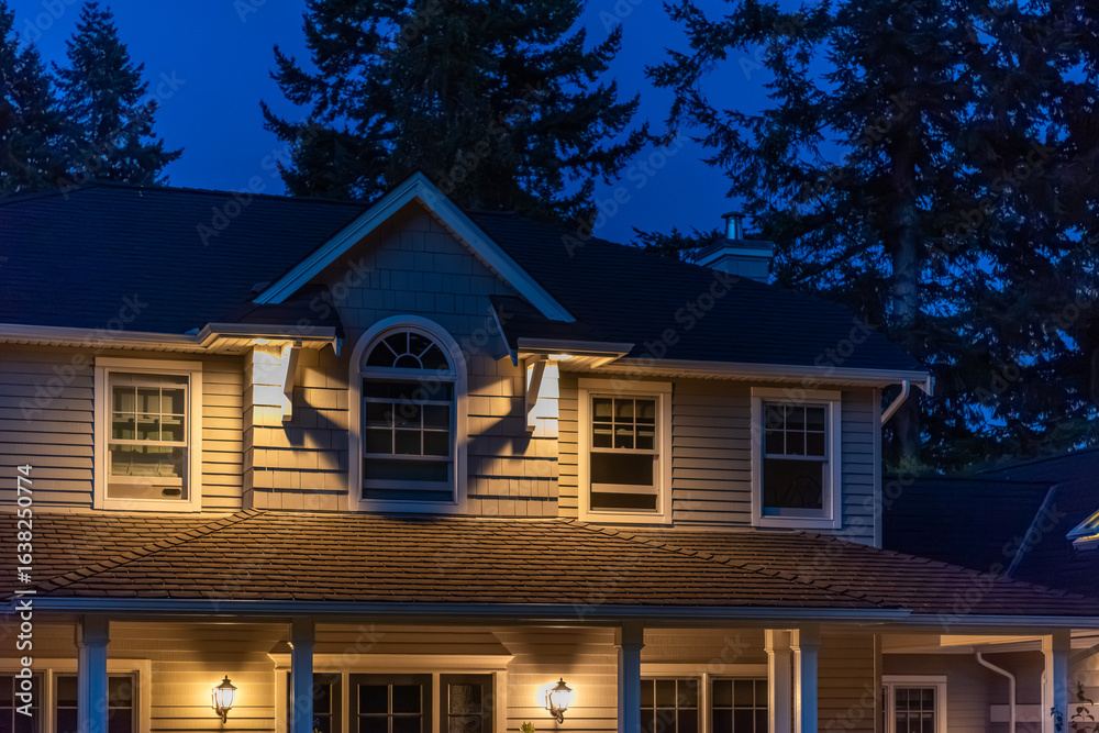 Fototapeta premium Fragment of luxury house with nice green Summer landscape at night in Vancouver, Canada, North America. August 2025.