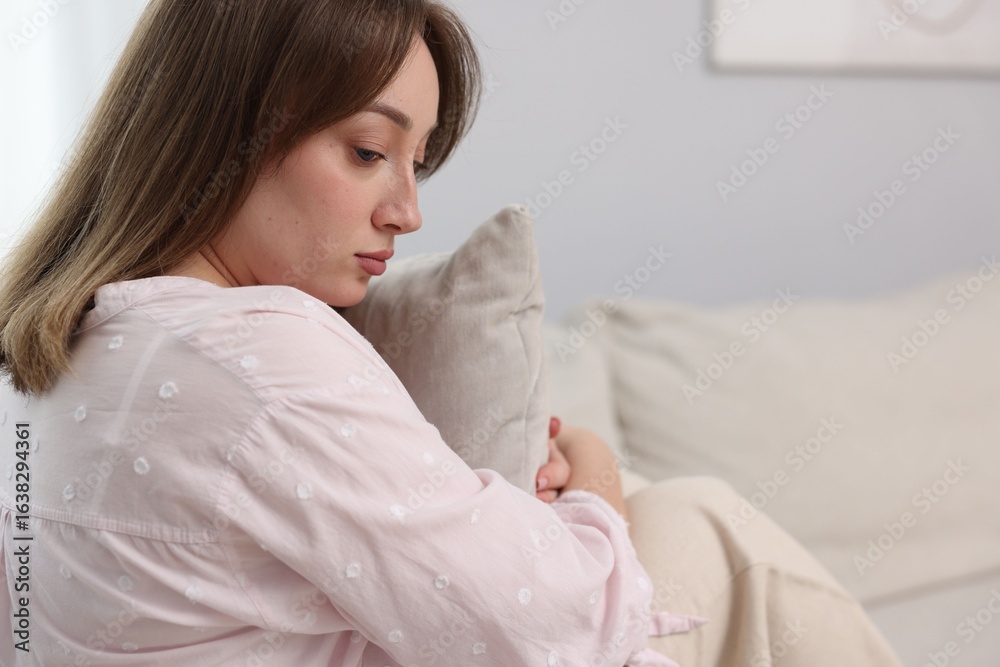 Betrayal. Lonely frustrated woman hugging pillow on sofa at home Betrayal. Lonely frustrated woman hugging pillow on sofa at home