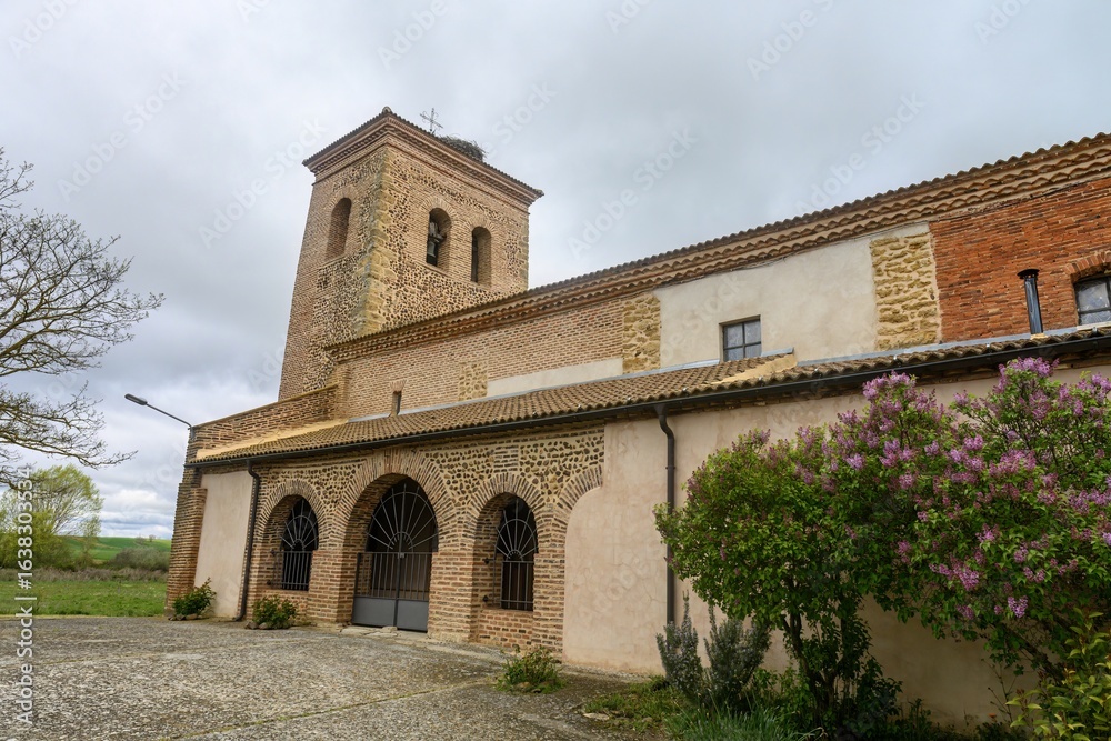 Fototapeta premium Church of Santa Ines in Villambroz, Palencia, with brick and stone bell tower