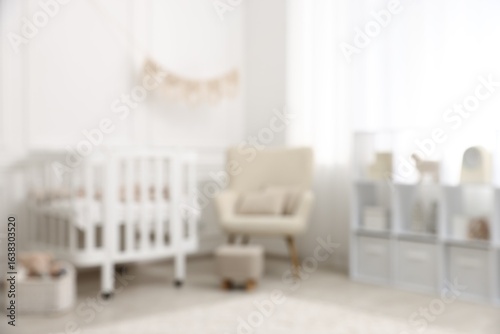 Baby room interior with crib and other furniture, blurred view