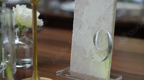 This stylish table number display with a beautiful floral arrangement is perfect for weddings and events