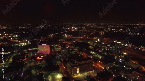 Wallpaper Mural Aerial view of a city skyline at night with colorful lights illuminating buildings Torontodigital.ca