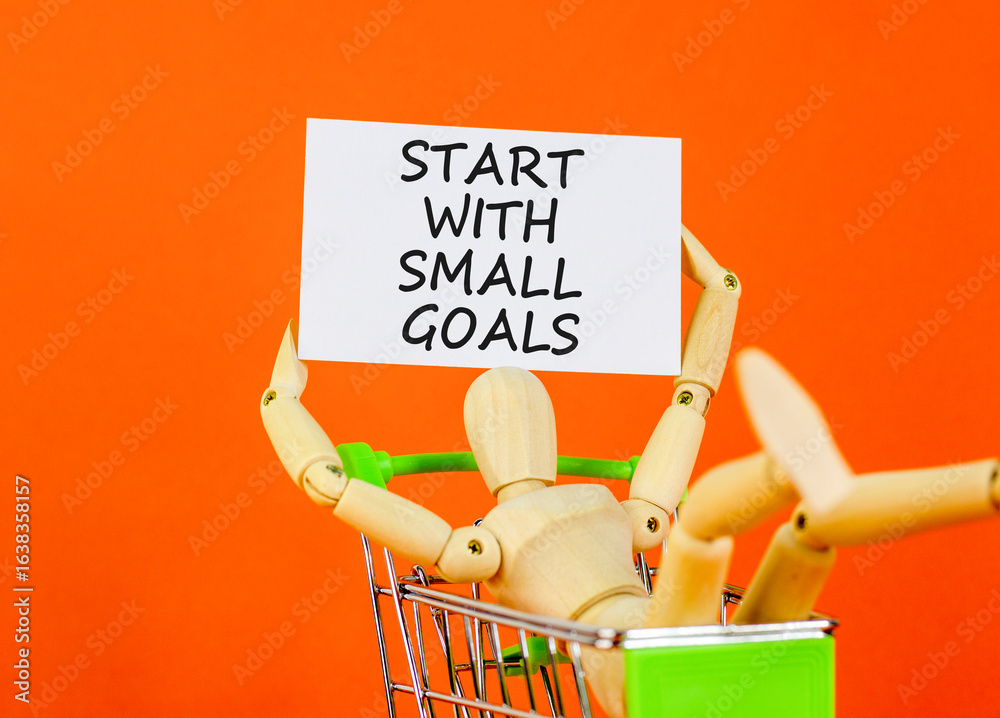 Start with small goals symbol. Concept words phrase Start with small goals on beautiful card. Businessman's model. Beautiful orange paper background. Business Start with small goals concept Copy space