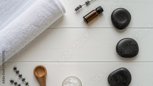 Spa Relaxation Setting with Towel Hot Stones Essential Oil and Lavender wellness beauty