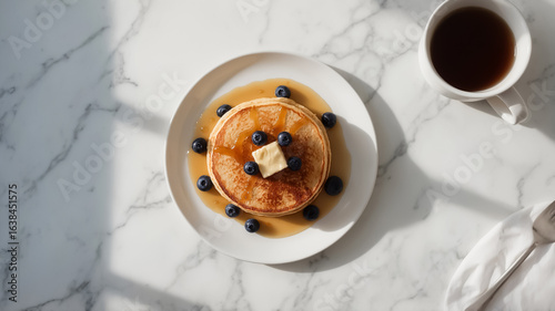 Stack of Golden Pancakes with Butter and Blueberries in Syrup with Coffee Cup breakfast food