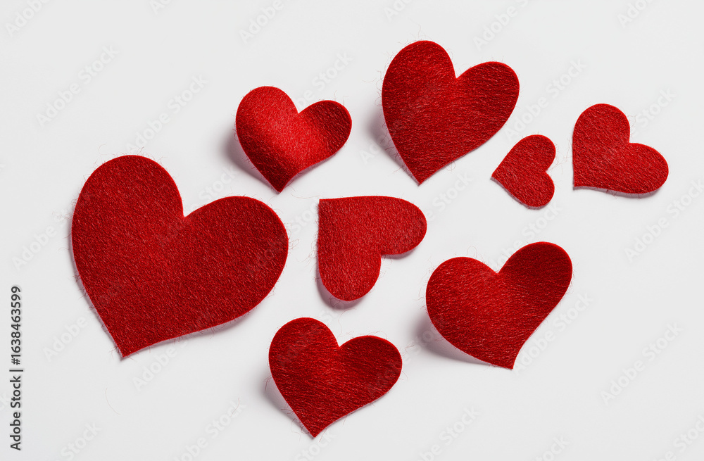 Fototapeta premium Felt red hearts floating on a transparent background, in a flat lay composition, heart, love, valentine, romance, day, hearts