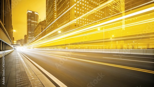 Streaking lights illuminate a city street at night with tall buildings nearby