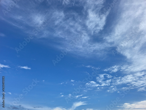 Blue Sky with White Fluffy Clouds. Natural Background for Weather, Nature, and Travel Concepts. High resolution sky texture wallpaper. Clear sunny morning sky.
