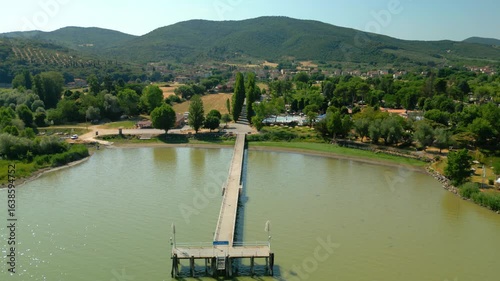 Lake trasimeno pier and shoreline in umbria, italy