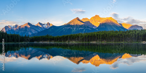Golden sunrise reflection on Herbert Lake, Banff National Park