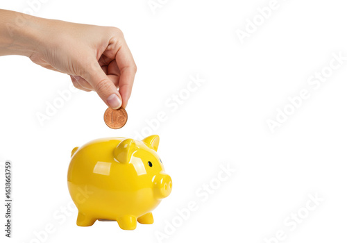 Saving money hand inserting coin into yellow piggy bank indoor bright setting perspective. Cut out png