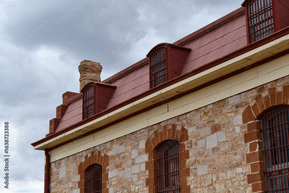 Obraz premium Barred windows of old prison facility.