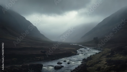 Dramatic Misty Valley: Winding River Through Rugged Mountains Under Overcast Sky